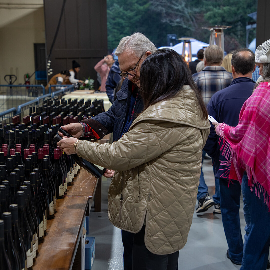 Couple reviewing cellar selection at WillaKenzie Estate